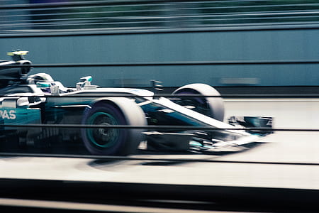 photo of green formula car on racing arena thumbnail