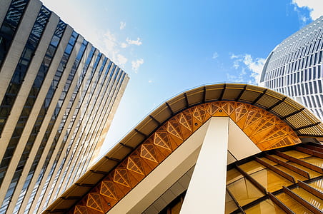 low-angle photography of beige and gray high-rise mirror building thumbnail