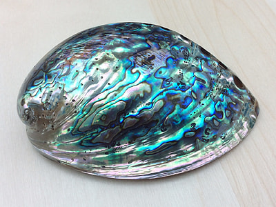 silver and blue ornament on top of gray surface thumbnail