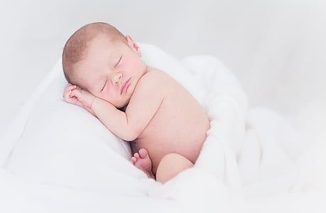 baby sleeping on white blanket thumbnail
