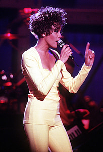 woman on stage holding microphone thumbnail