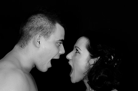 grayscale photo of man and woman facing each other thumbnail
