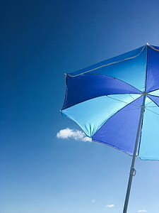 low angle photography of blue umbrella during daytime thumbnail