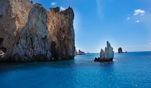 cliff beside sea under blue sky thumbnail