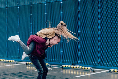 woman having a piggyback ride on back of the man thumbnail