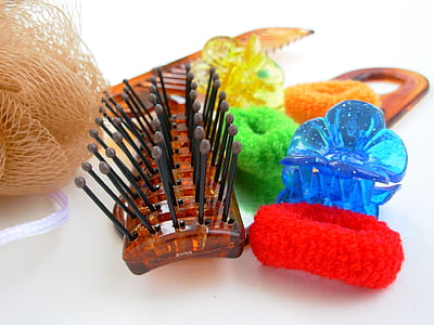brown hair brush beside blue hair pin thumbnail
