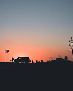 silhouette of vehicle and people during golden hour thumbnail