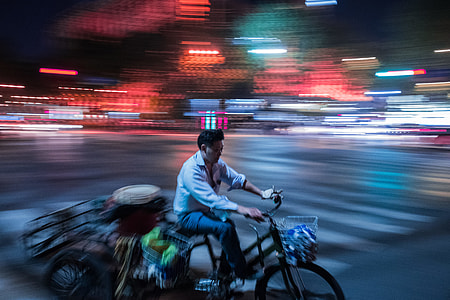 panning photo of man riding bicycle thumbnail