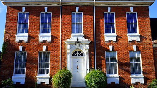 brown and white mansion during daytime thumbnail