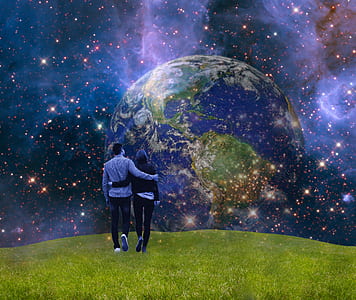 person standing on green field with universe wallpaper thumbnail