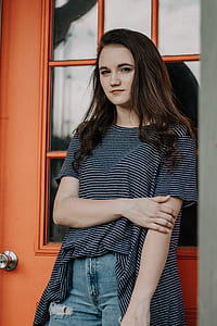 woman leaning on wooden door thumbnail