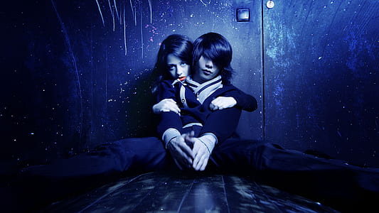 black haired man in front of woman thumbnail