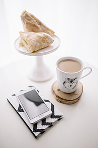 Black-and-white notebook and a white smartphone with various items thumbnail