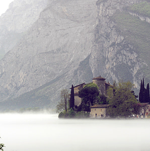 grey concrete house near mountain during fog thumbnail