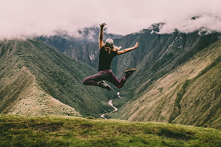 woman jumping near a cliff thumbnail