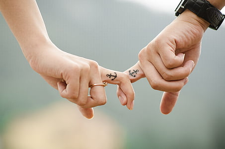 two person showing anchor finger tattoos thumbnail