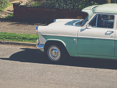 classic white and blue car on gray top road thumbnail