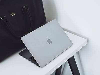 silver MacBook on white table thumbnail
