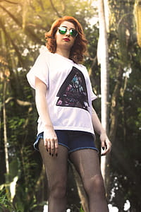 Low Angle Photo of Woman Near Tall Trees during Crepuscular Rays thumbnail