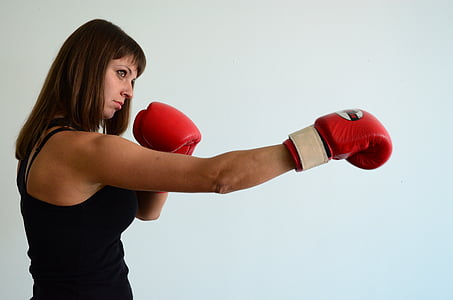 woman wearing red boxing gloves inside room thumbnail