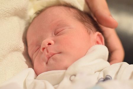 baby in white cloth sleeping thumbnail