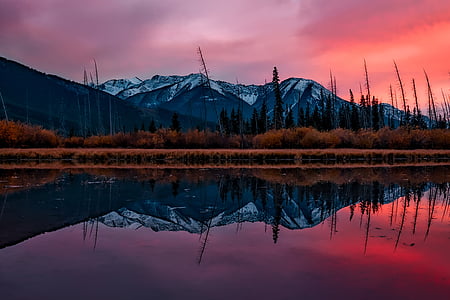 calm body of water next to mountains thumbnail
