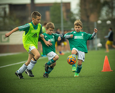boy's playing soccer during daytime thumbnail