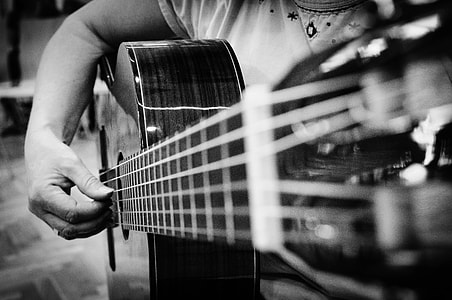 gray scale photo of person playing guitar thumbnail
