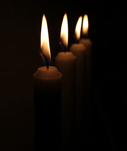 four aligned lighted candles close-up photography thumbnail