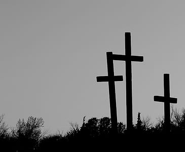 silhouette photography of three cross on ground thumbnail