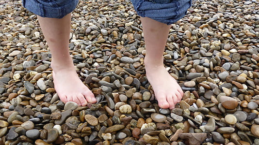 child standing on stones thumbnail
