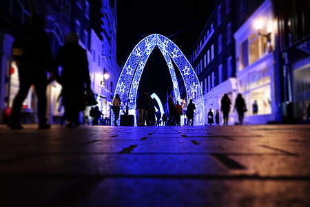 people walking toward blue and white star print pathway during night time thumbnail