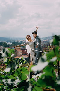 newly wed couple standing near railings thumbnail