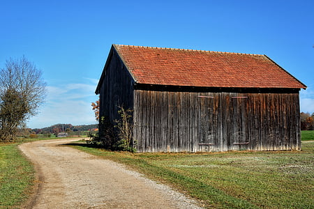 brown and black wooden barnhouse beside road thumbnail