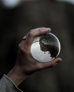 person holding clear glass ball thumbnail