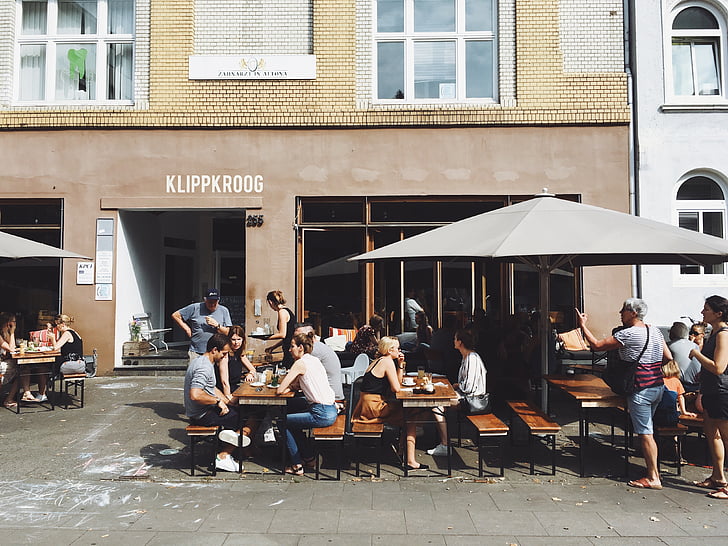 people sitting on brown steel picnic table