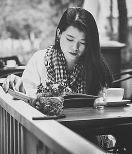 Grayscale Photography of Woman Reading thumbnail