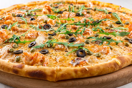 pizza with olives and green leaves thumbnail