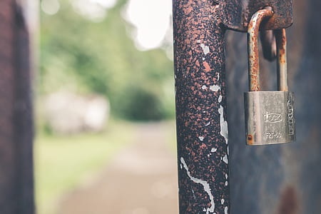 silver padlock on black gate thumbnail