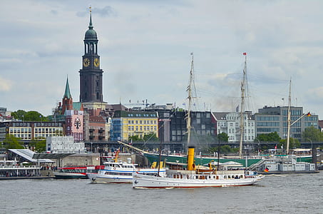 white ship on sea parked on multi-colored buildings thumbnail