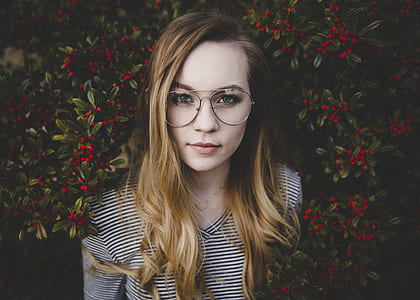 woman standing in front of red plant berries thumbnail