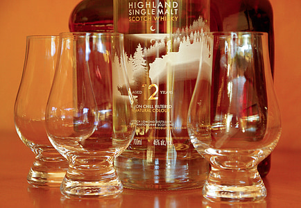 Highland Single Malt Scotch Whiskey bottle near three drinking glasses thumbnail