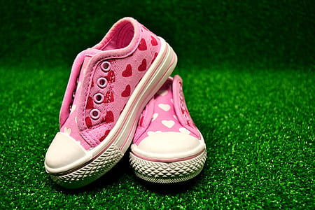 pair of toddler's pink heart low-top sneakers on green grass thumbnail