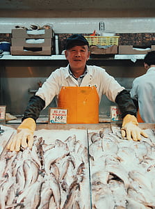 man holding fish on store thumbnail