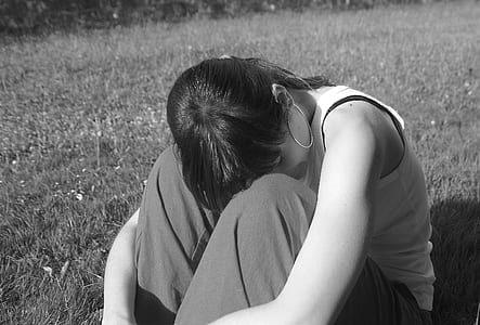 grayscale photo of woman sitting on gass thumbnail