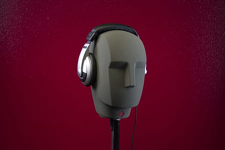 photo of black corded headphones with holder thumbnail