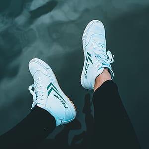 person wearing white low-top sneakers thumbnail