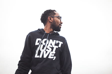 man wearing black pullover hoodie looking behind thumbnail