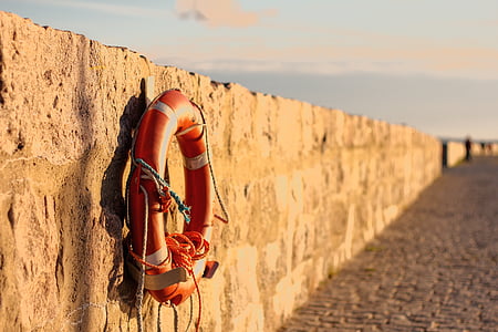 orange floater hanged on concrete wall thumbnail