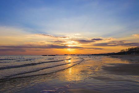 body of water under blue sky at snset thumbnail